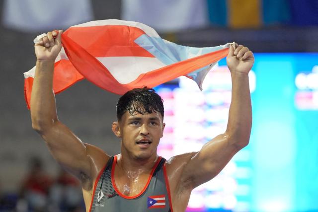 Puerto Rico’s Joseph Joseph celebrates after winning gold in the men's Greco-Roman 65kg wrestling final during the XXV Central American and Caribbean Games in Santo Domingo on July 31, 2026. (Photo by Francesco SPOTORNO / AFP)