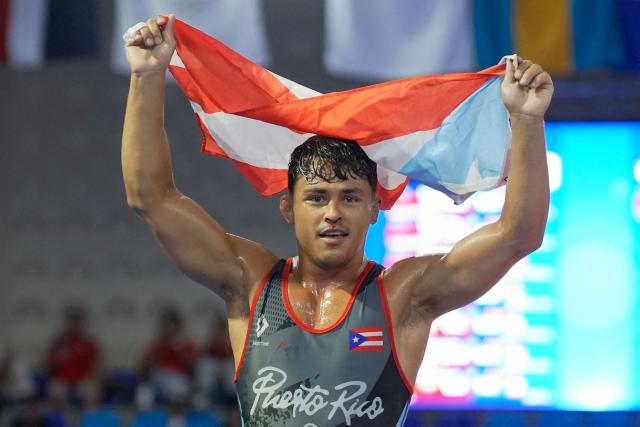 Puerto Rico’s Joseph Joseph celebrates after winning gold in the men's Greco-Roman 65kg wrestling final during the XXV Central American and Caribbean Games in Santo Domingo on July 31, 2026. (Photo by Francesco SPOTORNO / AFP)