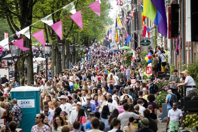 Attendees walk at the Prinsengracht during the Pride celebrations in the Dutch capital Amsterdam on August 1, 2026. (Photo by Ramon van Flymen / ANP / AFP) / Netherlands OUT