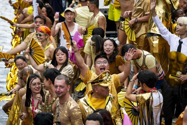 Participants react on the Asian Pride boat on a canal as they take part in the Canal Parade of the Pride celebrations in Amsterdam on August 1, 2026. (Photo by Remko de Waal / ANP / AFP) / Netherlands OUT