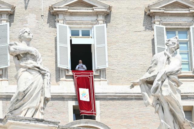 Pope Leo XIV addresses the crowd from the window of the apostolic palace overlooking St. Peter's square during the Angelus prayer in The Vatican on August 2, 2026. (Photo by Alberto PIZZOLI / AFP)