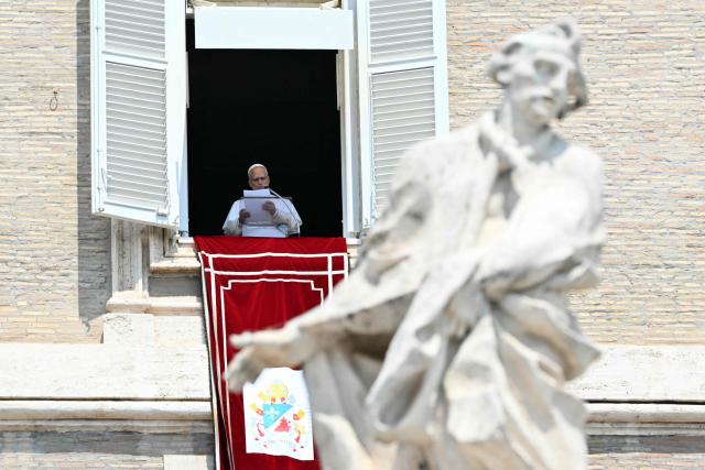 Pope Leo XIV addresses the crowd from the window of the apostolic palace overlooking St. Peter's square during the Angelus prayer in The Vatican on August 2, 2026. (Photo by Alberto PIZZOLI / AFP)