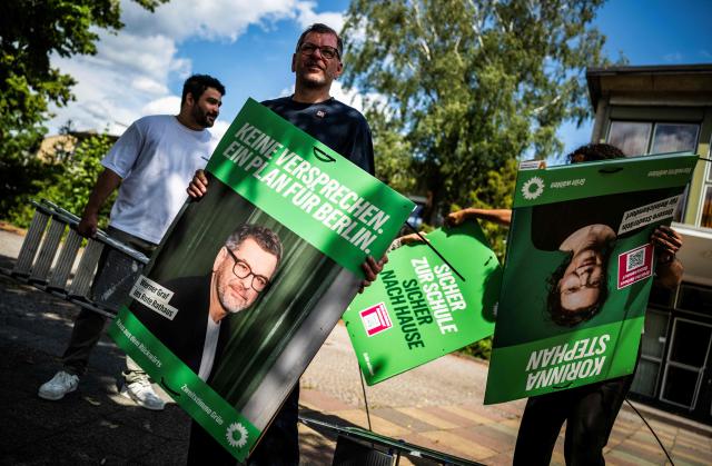 The Green Party's main candidate in upcoming regional elections in Berlin Werner Graf (C) and other activists prepare to hang campaign posters in Berlin's district of Reinickendorf on August 2, 2026. Berlin goes to the polls on September 20, 2026. (Photo by John MACDOUGALL / AFP)