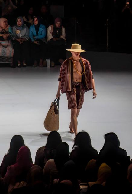 A model wears a contemporary ulos (a traditional woven product of the Batak people from North Sumatra) design themed "Legacy of North Sumatra" by designer Zul Zaid during the Indonesia Fashion Week in Jakarta on August 2, 2026. (Photo by ADITYA IRAWAN / AFP)