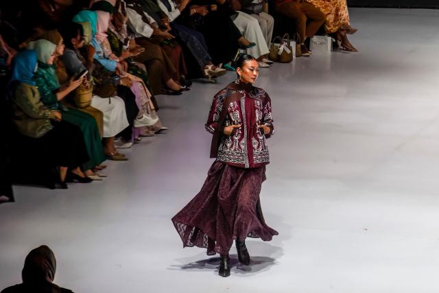A model wears a contemporary ulos (a traditional woven product of the Batak people from North Sumatra) design themed "Legacy of North Sumatra" by designer Dilla during the Indonesia Fashion Week in Jakarta on August 2, 2026. (Photo by ADITYA IRAWAN / AFP)