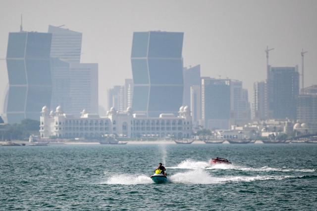 A man rides a personal watercraft in the Gulf waters off of Doha on August 2, 2026. (Photo by Mahmud HAMS / AFP)