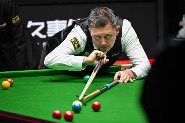 England's Kyren Wilson plays a shot during his match against England's Judd Trump at the Shanghai Masters snooker tournament in Shanghai on August 2, 2026. (Photo by Jade GAO / AFP)