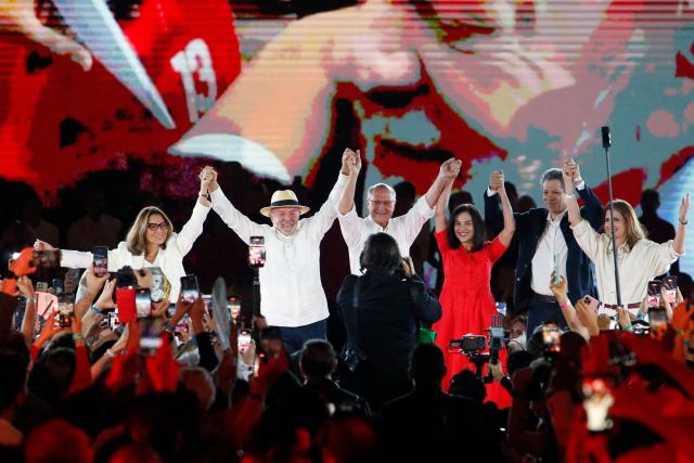 (L to R) Brazil's First Lady Janja Lula da Silva, Brazil's President Luiz Inacio Lula da Silva, Brazil's Vice President Geraldo Alckmin, Brazil's second lady Maria Lucia "Lu" Alckmin, Finance Minister Fernando Haddad and his wife Ana Estela Haddad raise their joined hands during the Workers' Party (PT) national convention in Sao Paulo, Brazil, on August 2, 2026, where Lula formally announced his bid for re-election. At 80, President Lula on July 2 launches his bid for re-election, casting himself as a defender of Brazil's "sovereignty" as pressure from President Donald Trump's administration casts a shadow over the campaign. (Photo by Miguel SCHINCARIOL / AFP)
