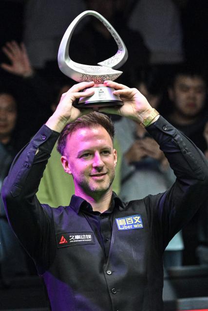 England's Judd Trump poses with his trophy after winning the final of the Shanghai Masters snooker tournament against England's Kyren Wilson in Shanghai on August 2, 2026. (Photo by Jade GAO / AFP)