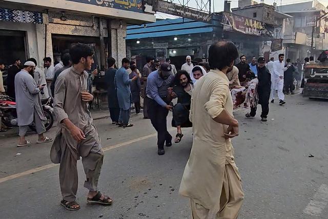 People evacuate injured victims following a suicide bombing during a protest in Pakistan's Swat district on August 2, 2026. A suicide bomber attacked a busy area near a police station during a protest in northern Pakistan's Swat district, killing seven people and wounding more than 20, police said on August 2. (Photo by Abdullah SHEREEN / AFP)
