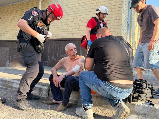 An injured person receives medical care at the site of a Russian airstrike in Zaporizhzhia on August 2, 2026, amid the Russian invasion of Ukraine. (Photo by Darya NAZAROVA / AFP)