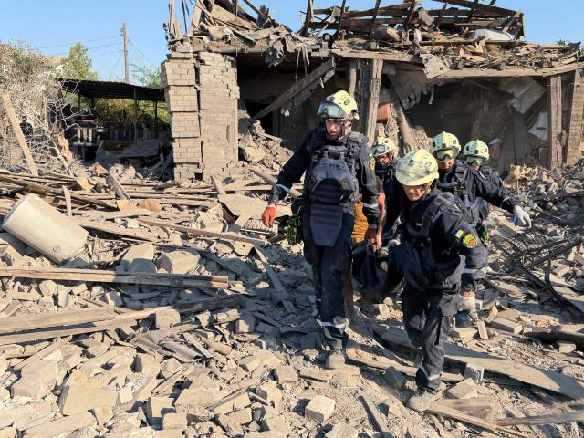 Ukrainian rescuers evacuate on a person on a stretcher at the site of a Russian airstrike in Zaporizhzhia on August 2, 2026, amid the Russian invasion of Ukraine. (Photo by Darya NAZAROVA / AFP)
