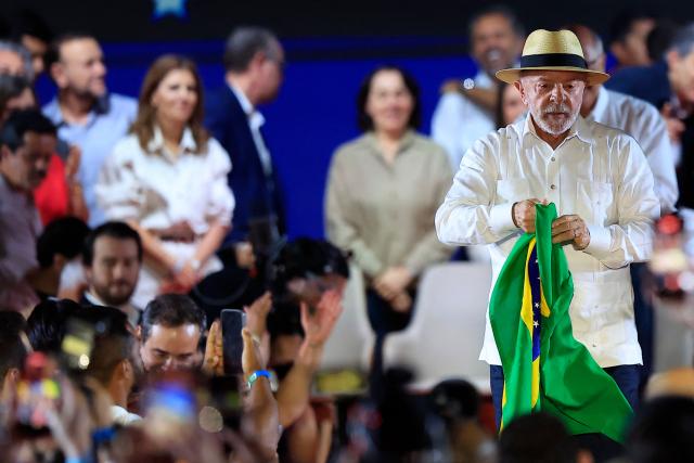 Brazil's President Luiz Inacio Lula da Silva holds a Brazilian flag during the Workers' Party (PT) national convention in Sao Paulo, Brazil, on August 2, 2026, where Lula formally announced his bid for re-election. At 80, President Lula on July 2 launches his bid for re-election, casting himself as a defender of Brazil's "sovereignty" as pressure from President Donald Trump's administration casts a shadow over the campaign. (Photo by Miguel SCHINCARIOL / AFP)