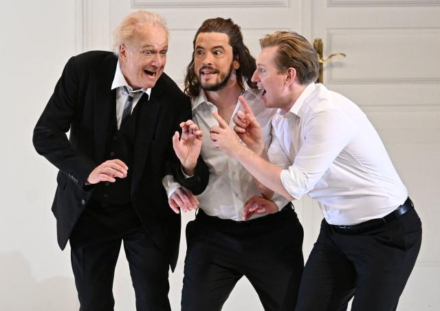 (L-R) Johannes Martin Kraenzle (Don Alfonso), Andre Schuen (Guglielmo) and Bogdan Volkov (Ferrando) perform on stage during a dress rehearsal for the opera "Cosi fan tutte" by Austrian Composer and musician Wolfgang Amadeus Mozart in Salzburg on August 2, 2026 during the Salzburg Festival. (Photo by BARBARA GINDL / APA / AFP) / Austria OUT