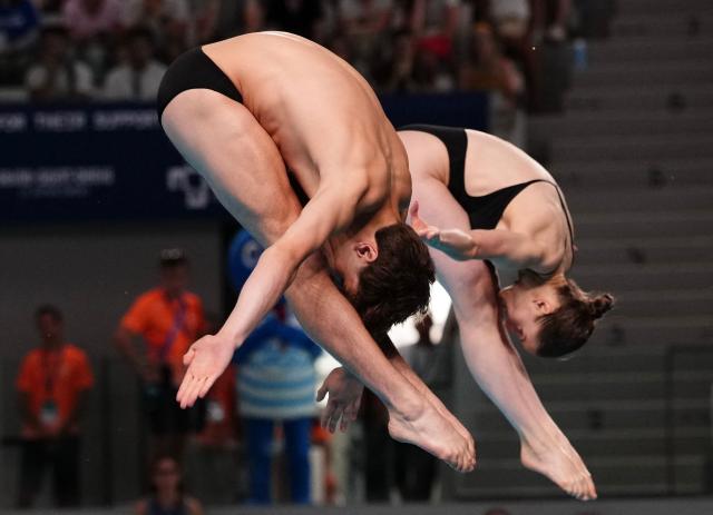 Switzerland's diver Erik Passerone and Switzerland's diver Michelle Luisa Heimberg compete in the mixed 3m synchro diving final event during the LEN European Aquatics Championships, at the Olympic Aquatics Centre in Saint-Denis, northeastern suburbs of Paris, on August 2, 2026. (Photo by Dimitar DILKOFF / AFP)