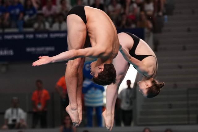 Switzerland's diver Erik Passerone and Switzerland's diver Michelle Luisa Heimberg compete in the mixed 3m synchro diving final event during the LEN European Aquatics Championships, at the Olympic Aquatics Centre in Saint-Denis, northeastern suburbs of Paris, on August 2, 2026. (Photo by Dimitar DILKOFF / AFP)