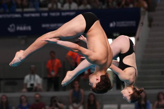 Switzerland's diver Erik Passerone and Switzerland's diver Michelle Luisa Heimberg compete in the mixed 3m synchro diving final event during the LEN European Aquatics Championships, at the Olympic Aquatics Centre in Saint-Denis, northeastern suburbs of Paris, on August 2, 2026. (Photo by Dimitar DILKOFF / AFP)