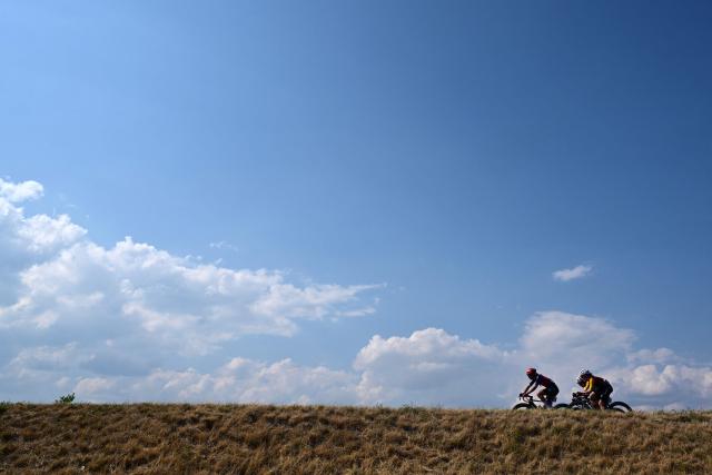 Riders in a breakaway including Human Powered Health's Italian rider Carlotta Cipressi (L) and Cofidis Women Team's French rider Ema Comte (R) compete during the second (out of 9) stage of the fifth edition of the Women's Tour de France cycling race, 147.9 km from Aigle to Geneva, in Aigle on August 2, 2026. (Photo by Nicolas TUCAT / AFP)