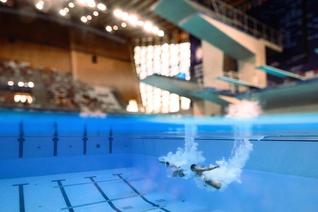 France's divers Gwendal Bisch and Nais Gillet compete in the mixed 3m synchro diving final event during the LEN European Aquatics Championships, at the Olympic Aquatics Centre in Saint-Denis, northeastern suburbs of Paris, on August 2, 2026. (Photo by SEBASTIEN BOZON / AFP)