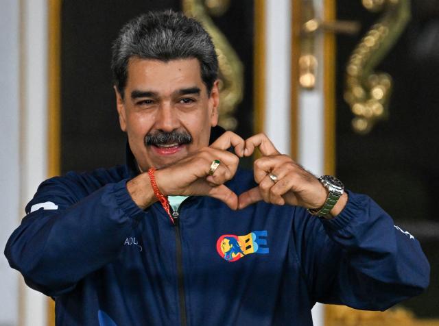 (FILES) Venezuela's President Nicolas Maduro gestures to supporters during the student day celebrations at Miraflores palace in Caracas, November 21, 2025. Ousted Venezuelan President Nicolas Maduro, who was captured by the US military in early January 2026, “welcomed” on August 2, 2026, from his prison in New York “any path toward dialogue,” as the government and the opposition are set to begin talks next week, under US supervision, that many hope will lead to a political transition and elections. (Photo by Juan BARRETO / AFP)