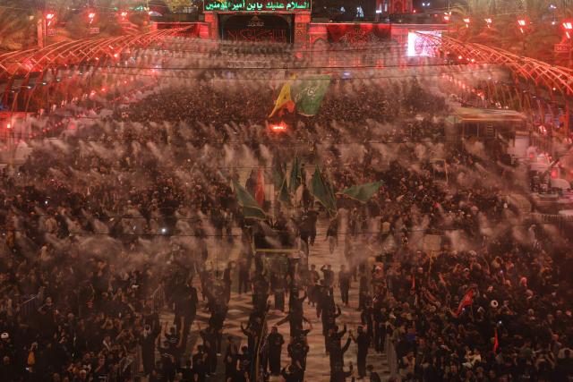 Shia Muslim pilgrims gather near the Imam al-Abbas Shrine in the holy city of Karbala, south of Baghdad on August 2, 2026, at the end of the Arbaeen pilgrimage, which commemorates 40 days of mourning after the martyrdom in the Battle of Karbala in 680 CE of Imam Hussein, the grandson of the Prophet Muhammad. The Arbaeen marks one of the most significant events in the Shia Muslim calendar, during which pilgrims, many from Iran, flock to Iraq to visit the holy shrines. (Photo by Ahmad AL-RUBAYE / AFP)