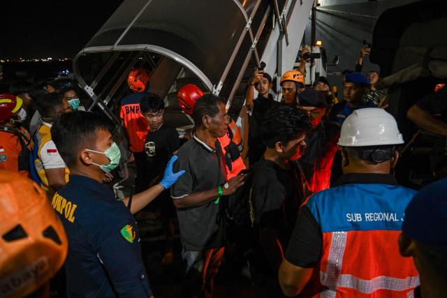 Survivors of the Mutiara Sentosa 2 ferry which caught fire in the waters off Madura island, East Java, on August 2, 2026, disembark at Tanjung Perak port in Surabaya early on August 3, 2026. An Indonesian ferry caught fire at sea on Sunday, killing five people and leaving another 41 missing after some jumped overboard, search and rescue officials said. A total of 225 people on the vessel were rescued, said the regional Surabaya Search and Rescue Agency, which provided the latest figures in an afternoon update. (Photo by JUNI KRISWANTO / AFP)