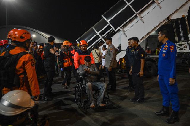 Survivors of the Mutiara Sentosa 2 ferry which caught fire in the waters off Madura island, East Java, on August 2, 2026, disembark at Tanjung Perak port in Surabaya early on August 3, 2026. An Indonesian ferry caught fire at sea on Sunday, killing five people and leaving another 41 missing after some jumped overboard, search and rescue officials said. A total of 225 people on the vessel were rescued, said the regional Surabaya Search and Rescue Agency, which provided the latest figures in an afternoon update. (Photo by JUNI KRISWANTO / AFP)