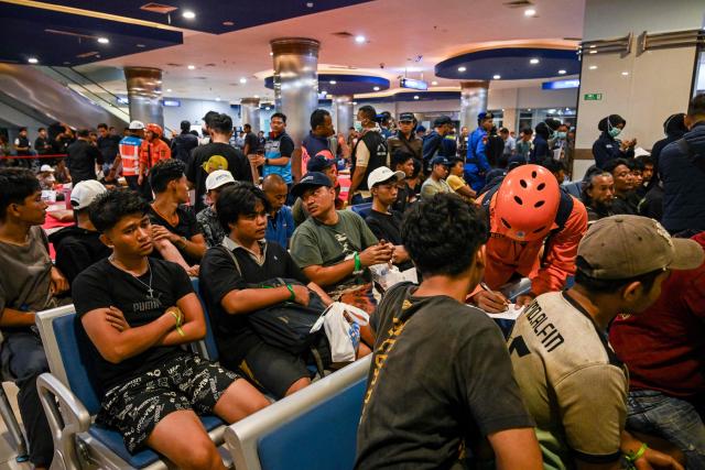 Survivors of the Mutiara Sentosa 2 ferry which caught fire in the waters off Madura island, East Java, on August 2, 2026, gather at Tanjung Perak port in Surabaya early on August 3, 2026. An Indonesian ferry caught fire at sea on Sunday, killing five people and leaving another 41 missing after some jumped overboard, search and rescue officials said. A total of 225 people on the vessel were rescued, said the regional Surabaya Search and Rescue Agency, which provided the latest figures in an afternoon update. (Photo by JUNI KRISWANTO / AFP)