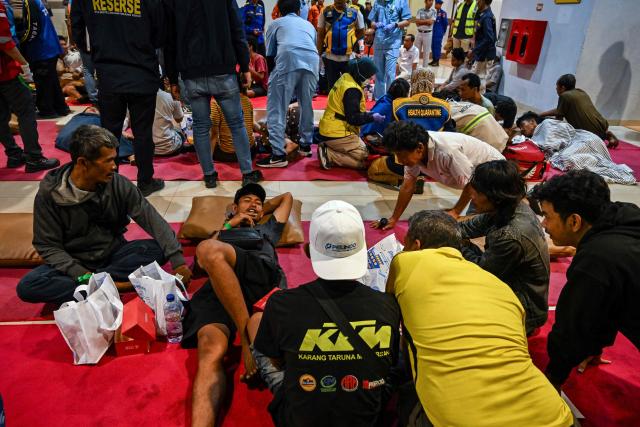 Survivors of the Mutiara Sentosa 2 ferry which caught fire in the waters off Madura island, East Java, on August 2, 2026, gather at Tanjung Perak port in Surabaya early on August 3, 2026. An Indonesian ferry caught fire at sea on Sunday, killing five people and leaving another 41 missing after some jumped overboard, search and rescue officials said. A total of 225 people on the vessel were rescued, said the regional Surabaya Search and Rescue Agency, which provided the latest figures in an afternoon update. (Photo by JUNI KRISWANTO / AFP)