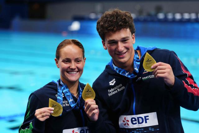 Gold medallists Italy's diver Matteo Santoro (R) and Italy's diver Chiara Pellacani celebrate on the podium after the mixed 3m synchro diving final event during the LEN European Aquatics Championships, at the Olympic Aquatics Centre in Saint-Denis, northeastern suburbs of Paris, on August 2, 2026. (Photo by Dimitar DILKOFF / AFP)