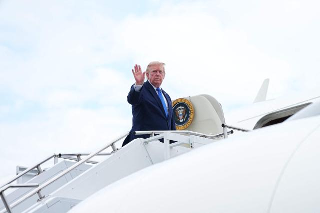 US President Donald Trump waves as he boards Air Force One at Morristown Municipal Airport in Morristown, New Jersey, on August 2, 2026. President Trump in returning to the White House after spending the weekend at his National Golf Club in Bedminster, following a cabinet meeting in Camp David, Maryland. (Photo by Aaron Schwartz / AFP)