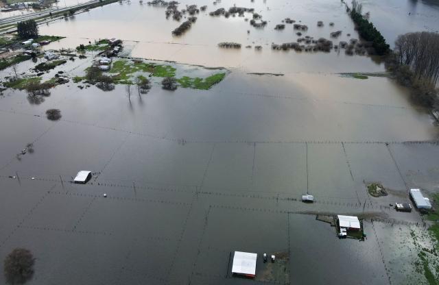 This aerial view shows a flooded area in the Arauco province, Bio Bio Region, southern Chile, on August 2, 2026, following heavy rains that affected the region. At least two people have died and 300 more have been affected by a severe storm battering central and southern Chile, authorities reported on he eve. (Photo by Guillermo SALGADO / AFP)