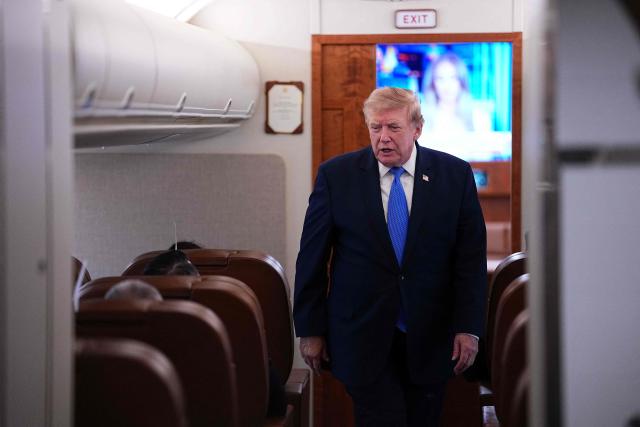 US President Donald Trump walks to speak to the press aboard Air Force One on August 2, 2026. Trump is returning to the White House after spending the weekend in New Jersey at his Bedminster residence. (Photo by Aaron Schwartz / AFP)