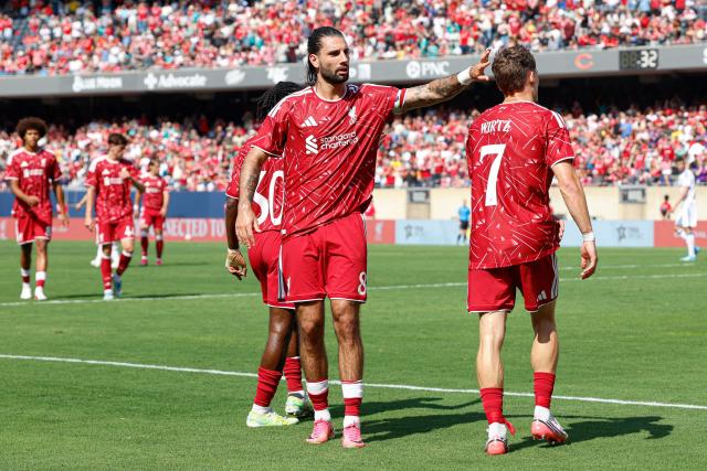 Liverpool's German midfielder #07 Florian Wirtz (R) is congratulated by Liverpool's Hungarian midfielder #08 Dominik Szoboszlai (C) after scoring during the first half of the pre-season friendly football match between Liverpool FC and Leeds United FC at Soldier Field in Chicago, Illinois, on August 2, 2026. (Photo by KAMIL KRZACZYNSKI / AFP)
