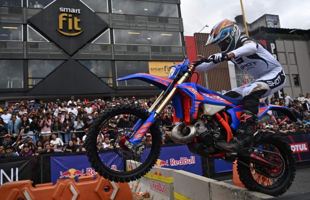 A rider competes during the first enduro race held through the streets of the city at the Red Bull Moto Urbano event in Bogota on August 2, 2026. (Photo by Raul ARBOLEDA / AFP)