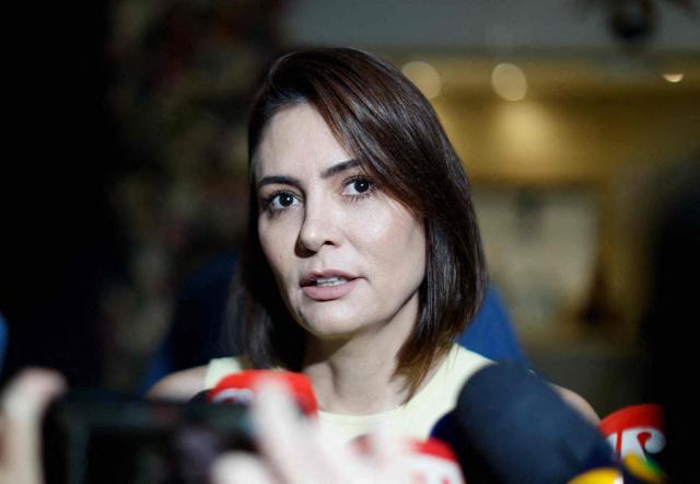 (FILES) Former First Lady of Brazil Michelle Bolsonaro, wife of convicted former President Jair Bolsonaro, speaks to the media as she leaves a store near her house in Brasilia on July 31, 2026. On August 2, 2026, Brazil's former first lady, Michelle Bolsonaro, announced her bid for the Senate, following several weeks of speculation about her candidacy due to differences with her stepson and presidential candidate, Flavio Bolsonaro. (Photo by Sergio Lima / AFP)