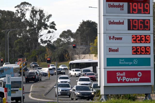 Vehicles pass a petrol station displaying updated fuel prices in Sydney on August 3, 2026, following the expiry of the Australian government's temporary fuel excise relief. (Photo by SAEED KHAN / AFP)