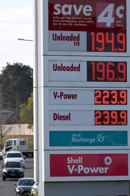 Vehicles pass a petrol station displaying updated fuel prices in Sydney on August 3, 2026, following the expiry of the Australian government's temporary fuel excise relief. (Photo by SAEED KHAN / AFP)