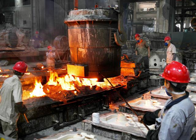 Workers pour molten metal at the foundry workshop of Zhejiang Wujing Machinery Manufacturing in Wuyi, eastern China's Zhejiang province on August 3, 2026. (Photo by CN-STR / AFP) / China OUT