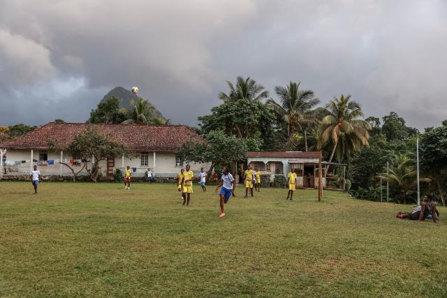 Residents play football in Monte Alegre, near Santo Antonio, in Príncipe Island in São Tomé and Príncipe, on August 2, 2026. Situated in the northwestern part of Príncipe Island, Monte Alegre (also known as Montalegre) is a historic former plantation (roça) and natural landmark featuring a scenic hiking trail and waterfall located in the northwest of Príncipe Island. (Photo by Daniel BELOUMOU OLOMO / AFP)