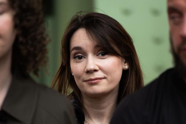 (FILES) Xenia Fedorova (C), the former director of the French version of Russian state-run foreign language channel RT, which was banned in France after the Russian invasion of Ukraine, reacts as activists of the organization "For Ukraine, for their freedom and ours" stage a protest against her presence to promote her book untitled "Bannie" ("Banned"), at the stand of French publishing house Fayard during the "Festival du Livre de Paris 2025" book fair at the Grand Palais venue in Paris on April 12, 2025. On August 3, 2026, the Paris Administrative Court rejected an urgent application for the protection of civil liberties filed by pro-Russian commentator Xenia Fedorova against her expulsion from the country and the freezing of her assets, on the grounds that she had failed to demonstrate an "extreme urgency". (Photo by Xavier GALIANA / AFP)