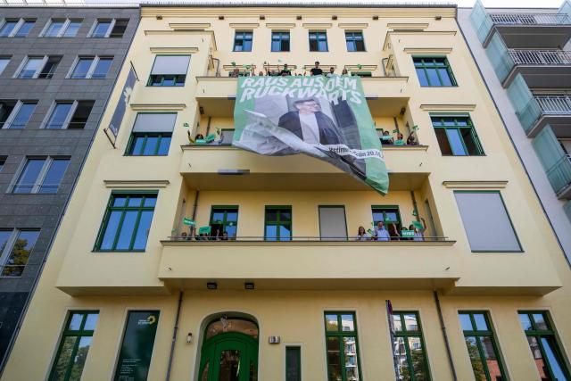 Activists of the Green Party unfurl a giant election campaign banner featuring the Green Party's main candidate in upcoming regional elections in Berlin Werner Graf on the facade of the Green Party's federal headquarters in Berlin on August 3, 2026. Berlin goes to the polls on September 20, 2026. (Photo by John MACDOUGALL / AFP)
