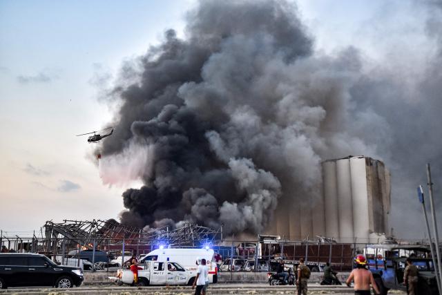 EDITORS NOTE: Graphic content / (FILES) A helicopter puts out a fire at the scene of an explosion at the port of Lebanon's capital Beirut on August 4, 2020. Lebanese President Joseph Aoun on August 3, 2026 urged the judiciary to issue a long-awaited indictment over the 2020 Beirut port blast, on the eve of the catastrophe's sixth anniversary. (Photo by AFP)