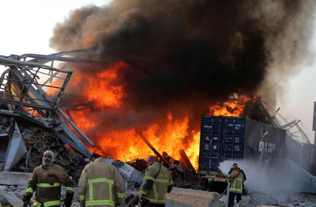 EDITORS NOTE: Graphic content / (FILES) Lebanese firefights extinguish fire at the scene of an explosion at the port in the capital Beirut on August 4, 2020. Lebanese President Joseph Aoun on August 3, 2026 urged the judiciary to issue a long-awaited indictment over the 2020 Beirut port blast, on the eve of the catastrophe's sixth anniversary. (Photo by AFP)