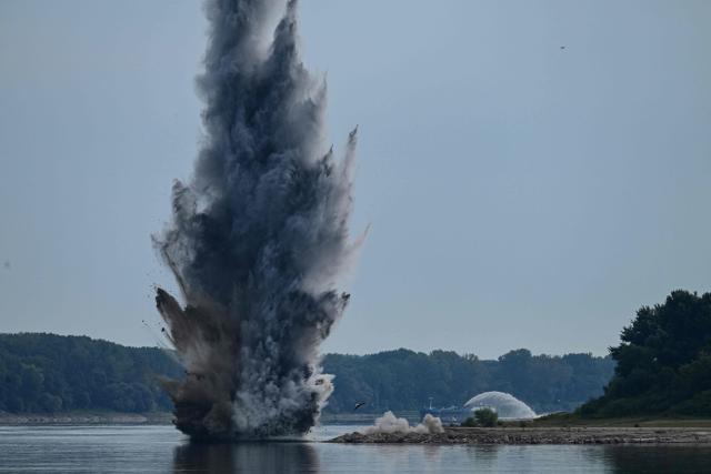 A controlled underwater explosion is pictured on the riverbed of the Danube River in Izvoarele village, on August 3, 2026. The blast aimed at deepening the channel and diverting a higher volume of water toward the cooling systems of the Cernavoda Nuclear Power Plant. Local authorities and plant engineers authorized the blasting operations to counteract critically low water levels caused by a prolonged summer heatwave, ensuring the continuous and safe operation of the facility's reactors. (Photo by Daniel MIHAILESCU / AFP)
