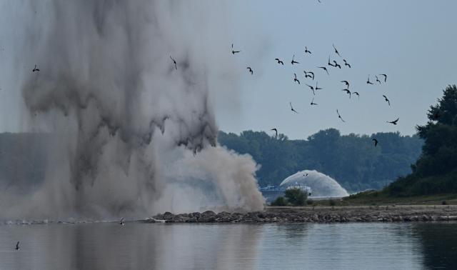 A controlled underwater explosion is pictured on the riverbed of the Danube River in Izvoarele village, on August 3, 2026. The blast aimed at deepening the channel and diverting a higher volume of water toward the cooling systems of the Cernavoda Nuclear Power Plant. Local authorities and plant engineers authorized the blasting operations to counteract critically low water levels caused by a prolonged summer heatwave, ensuring the continuous and safe operation of the facility's reactors. (Photo by Daniel MIHAILESCU / AFP)
