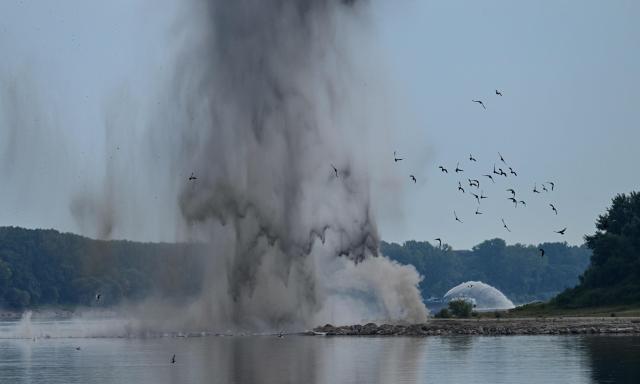 A controlled underwater explosion is pictured on the riverbed of the Danube River in Izvoarele village, on August 3, 2026. The blast aimed at deepening the channel and diverting a higher volume of water toward the cooling systems of the Cernavoda Nuclear Power Plant. Local authorities and plant engineers authorized the blasting operations to counteract critically low water levels caused by a prolonged summer heatwave, ensuring the continuous and safe operation of the facility's reactors. (Photo by Daniel MIHAILESCU / AFP)