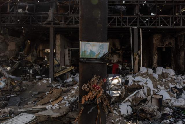This photograph shows a portrait of victims attached to a petrol station destroyed in a Russian air strike in the town of Izium, in the eastern Kharkiv region, on July 29, 2026, amid the Russian invasion of Ukraine. (Photo by Roman PILIPEY / AFP)