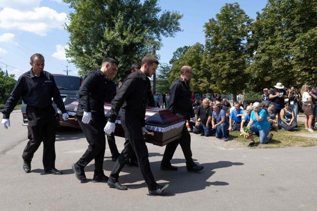 Pallbearers carry the coffin of a family member who was killed on July 30, 2026, during a funeral ceremony in Kryvyi Rig on August 3, 2026, amid the Russian invasion of Ukraine. A Ukrainian emergency services official had previously told AFP that the deaths of six people had been confirmed, while four others were presumed dead but had yet to be formally identified. (Photo by Serhii Okunev / AFP)