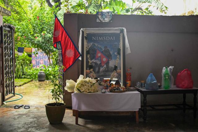 A garlanded portrait of deceased mountaineer Nirmal Purja is seen at his home in Chitwan on August 3, 2026, after his demise in an avalanche on Pakistan's Broad Peak. Rescuers recovered the body of renowned climber Nirmal Purja on August 2 after an avalanche killed him and nine team members on one of the world's highest peaks in northern Pakistan, the Alpine Club of Pakistan said. (Photo by PRAKASH MATHEMA / AFP)